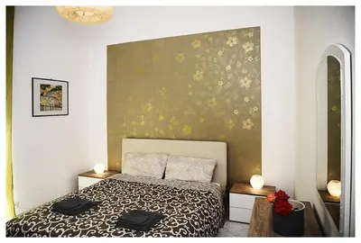 a bedroom with a bed with a black and white comforter at Raffa al Pigneto in Rome