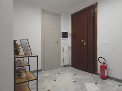 a living room with a door and a fire extinguisher at Rome sweet home - Casa Cesari in Rome