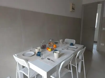 a white table with white chairs and oranges on it at Rome sweet home - Casa Cesari in Rome
