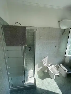 a bathroom with a shower and a toilet and a sink at Casa cozy e luminosa - Tiburtina in Rome