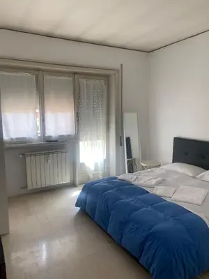a bedroom with a bed with a blue blanket on it at Scalia gest in Rome