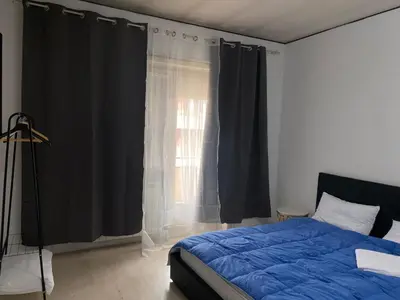 a bedroom with a blue bed and a window at Scalia gest in Rome