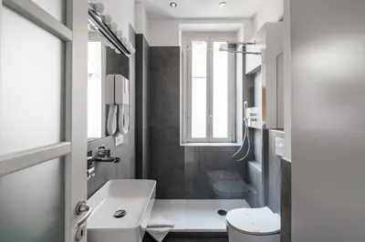 a white bathroom with a sink and a toilet at Nauta Rome - Comfort e Design in Rome