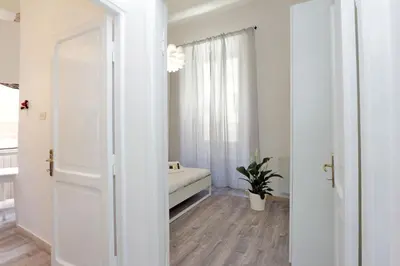 an open door to a room with a bed and a window at DaliTourism - Colosseo Experience 28 in Rome