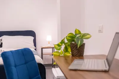 a laptop sitting on a desk next to a bed at Pallaro 6 room in Rome