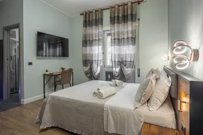 a bedroom with a bed and a window and a table at Aurelia Garden Suite in Rome