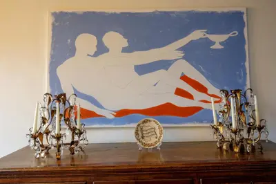 a painting on top of a wooden table with two candles at Terrazza Altavista - Aeternum Urbe in Rome