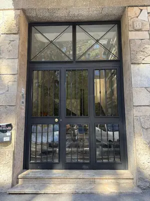a black door with windows on a stone building at Vatican Charming Retreat by NDP rent in Rome
