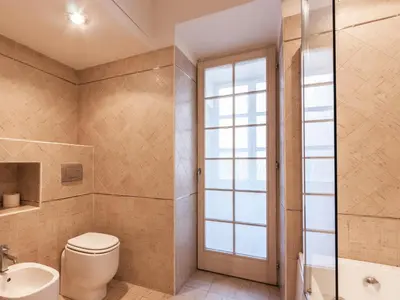 a bathroom with a toilet and a sink at La Piccola Maison in Rome