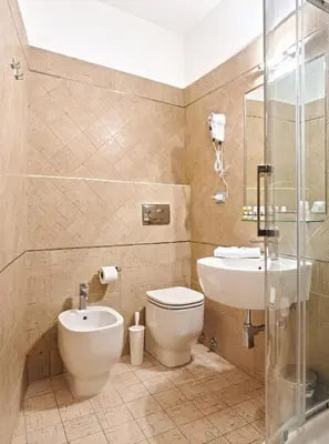 a bathroom with a toilet and a sink at La Piccola Maison in Rome