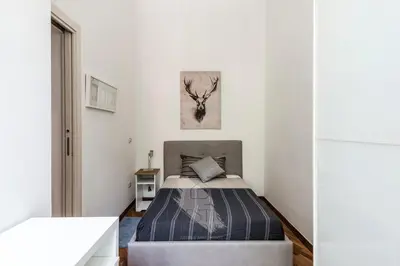 a bedroom with a bed and a deer picture on the wall at Vatican Gallery Apartment in Rome