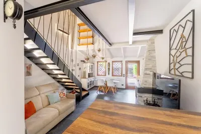 a living room with a staircase and a couch at Suede Loft Retreat, Charm, Relax Private Parking in Rome