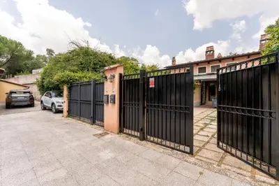 a black gate in front of a house at Suede Loft Retreat, Charm, Relax Private Parking in Rome