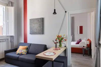a living room with a couch and a table at Now Apartments, ApartHotel in the heart of Rome in Rome