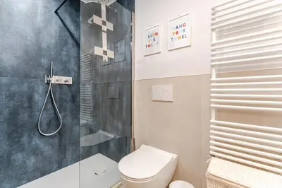 a bathroom with a toilet and a shower at Refined two-bedrooms Roman Residence in Rome