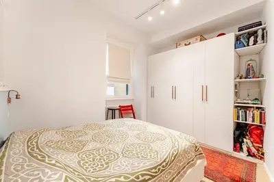 a bedroom with a bed and a white cabinet at Refined two-bedrooms Roman Residence in Rome