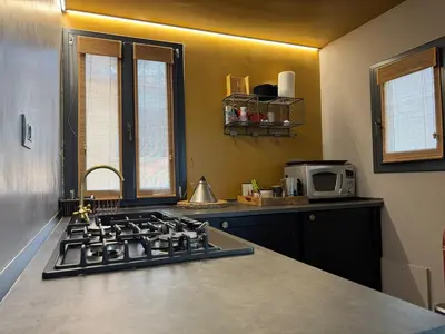 a kitchen with a stove top oven next to a microwave at Monti Penthouse in Rome