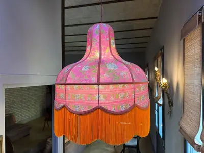 a pink and orange chandelier hanging from a ceiling at Monti Penthouse in Rome