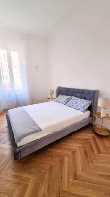 a large bed in a bedroom with a wooden floor at Beautiful Apartment San Pietro in Rome