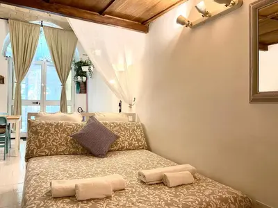 a bedroom with a bed with two pillows on it at Trastevere Loft Leopardo in Rome