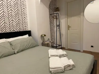 a bedroom with a bed with towels on it at Casa Amicitia Piazza di Spagna in Rome