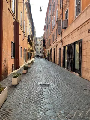 an empty street in an alley between buildings at Casa Amicitia Piazza di Spagna in Rome