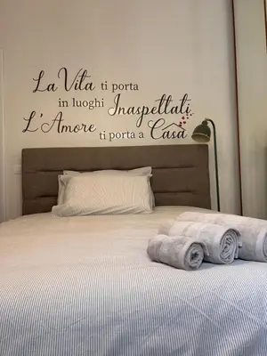 a bedroom with a bed with towels on it at A casa di Tony in Rome