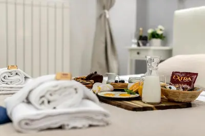 a table with towels and a tray of food at Bella Roma Luxury Accommodation, Vatican City - Liberty Collection in Rome