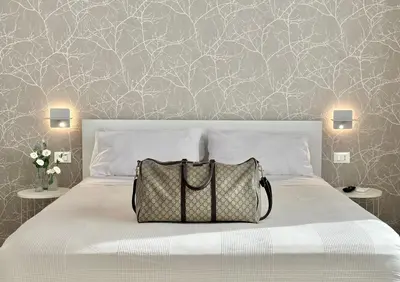 a bedroom with a bed with a bag on it at Casa Colli in Rome