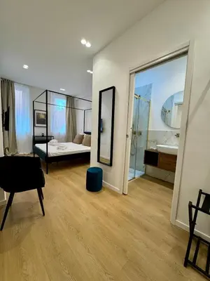 a room with a bedroom and a bed and a mirror at Scala 37 interno 1, Trastevere, Rome in Rome