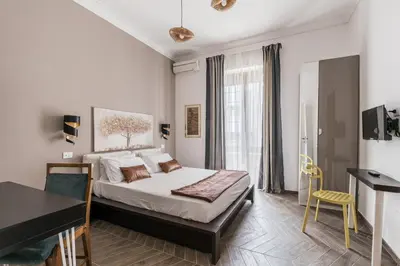 a bedroom with a bed and a desk and a piano at 59 Riverside in Rome