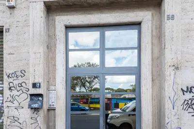 a window of a building with graffiti on it at 59 Riverside in Rome