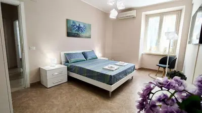 a bedroom with a bed and a chair in it at Metronia Maison in Rome