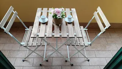 a table with chairs and a basket of flowers on it at Metronia Maison in Rome