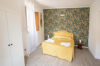 a bedroom with a bed with a yellow bedspread at Torpigna Rainbow in Rome