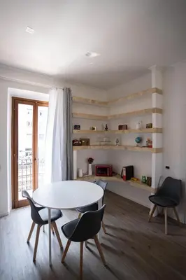 a living room with a white table and chairs at Torpigna Rainbow in Rome