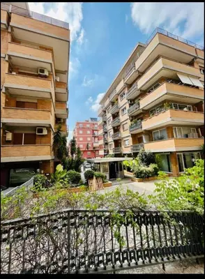 an apartment building with a fence in front of it at Amazing Roma Vaticano in Rome