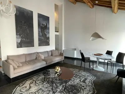 a living room with a couch and a table at Monti luxury penthouse in Rome