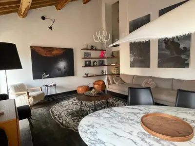 a living room with a table and a couch at Monti luxury penthouse in Rome