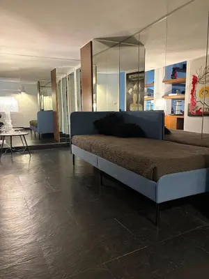 a bedroom with a bed with a glass wall at Monti luxury penthouse in Rome