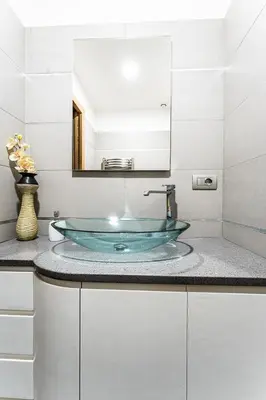 a bathroom with a glass sink and a mirror at Domus Villae Rome Spanish Steps in Rome