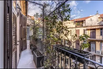 an apartment balcony with potted plants on it at Barberini Apartment in Rome