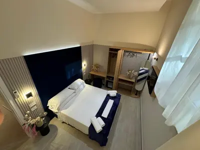 a hotel room with a bed and a desk at Settecento Guest House in Rome