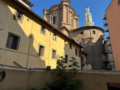 a building with a clock tower and a church at Settecento Guest House in Rome