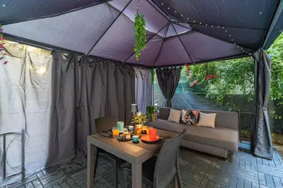 a patio with a table and a purple umbrella at Imperial Garden Suite - 300 m to Metro B, A-C, Rome in Rome