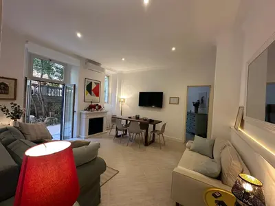 a living room with a couch and a table at Villa Borghese Home & Terrace in Rome