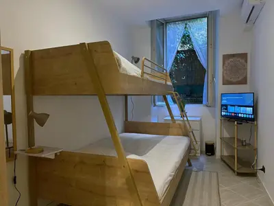 a bedroom with two bunk beds and a laptop at Villa Borghese Home & Terrace in Rome