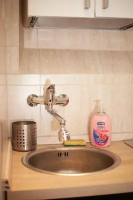 a bathroom with a red sink and a mirror at Ludovisi seminterrato loft in Rome