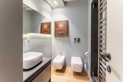 a bathroom with a white sink and a toilet at Zenaria Trastevere, Zen Design in Heart of Rome in Rome