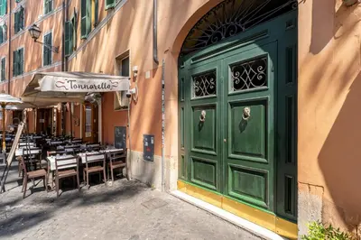 a green door of a restaurant with tables and chairs at Zenaria Trastevere, Zen Design in Heart of Rome in Rome